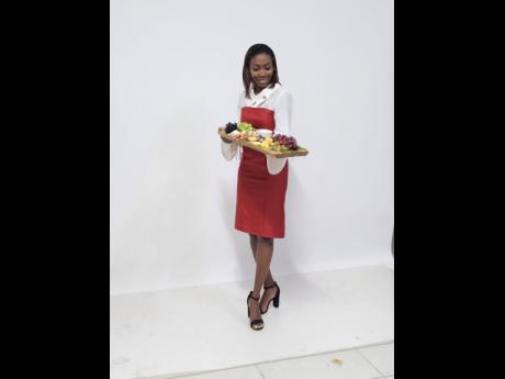 Credit: Contributed Boujee Boards by Tiff’s Tiffany Foster proudly poses with a charcuterie board.