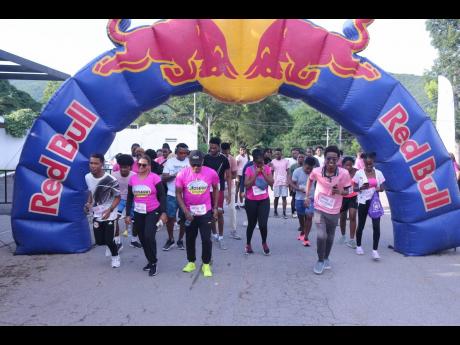 They’re off! The UWI Guild Pink Run kicks off with Lifespan reps Nayana Williams and Olaf Blackwood at fore.