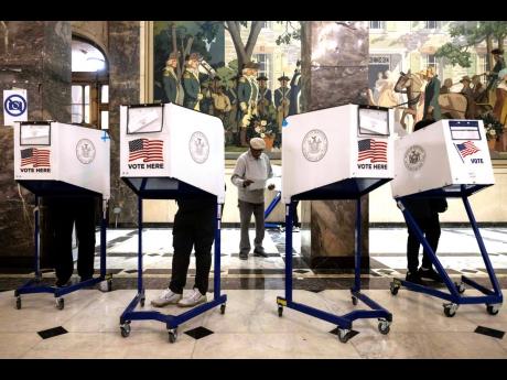 Voters cast their ballots in US presidential election yesterday.