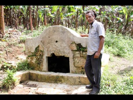 Credit: File Tour guide Michael Grizzle stands beside a well in Flagstaff, St James, which was built by the British soldiers to support the barracks with water after the 1795 war between the British and the Maroons.