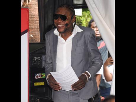 Dancehall artiste, Vybz Kartel makes his entrance at the Freedom Street press conference held at Janga’s Soundbar & Grill on Wednesday morning.