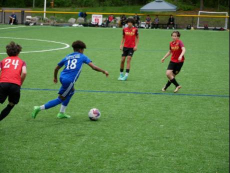 BTW Gottschee’s Matthew Campbell (left) dribbles at Veleo Futbol Club players during an MLS Next15 tournament recently.