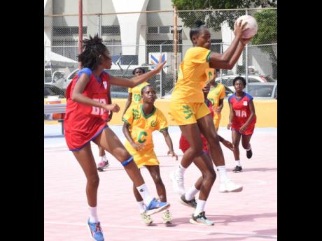 St Jago High School’s Poshanna-Lee Blake (right) grabs a pass ahead of Camperdown High School’s Cashante Samuels during an ISSA urban schoolgirls netball second-round game at the Leila Robinson Courts on November 15, 2023.