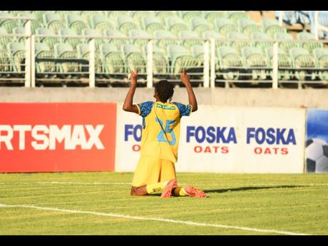 Tyrone Mullings of Racing United celebrates after scoring against  Chapelton Maroons during their Jamaica Premier League match  at Sabina Park, yesterday.