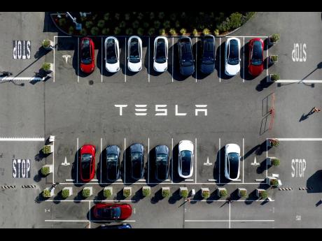 Tesla vehicles line a parking lot at the company’s Fremont, California factory, on September 18, 2023.