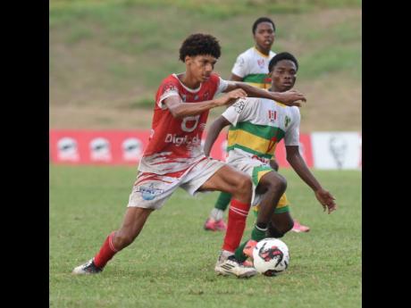 Campion College stand-in captain, Djaz Less (left), drives past Excelsior’s Kimarly Scott during their ISSA Manning Cup quarter-final game at the Stadium East Sports Complex yesterday.