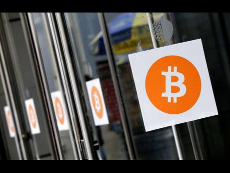Credit: AP
Bitcoin logos are displayed at the ‘Inside Bitcoins’ conference and trade show on April 7, 2014, in New York.