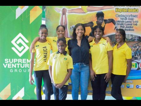 Supreme Ventures Limited (SVL) Marketing Manager Jhana Edwards shares a moment with members of Team Jamaica gymnasts during the inaugural Carifta Gymnastic Press Launch at the Jamaica School of Gymnastics on Thursday.