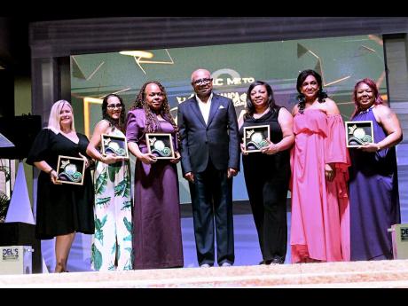 Credit: Contributed Tourism Minister Edmund Bartlett and executive director, Jamaica Vacations (JamVac), Joy Roberts (second right), with travel advisor awardees during the second annual Regal Awards at Sandals Ochi Beach in Ocho Rios, St Ann, on Saturday, November 16. The aw