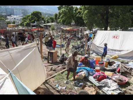 Residents of the Nazon neighbourhood displaced by gang violence construct a tent encampment, in Port-au-Prince, Haiti on Friday, November 15.