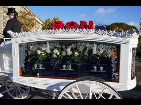 Credit: AP A horse-drawn carriage carrying the coffin of Liam Payne arrives for the funeral service of the One Direction singer at St Mary's Church in Amersham, Buckinghamshire, England, on Wednesday.