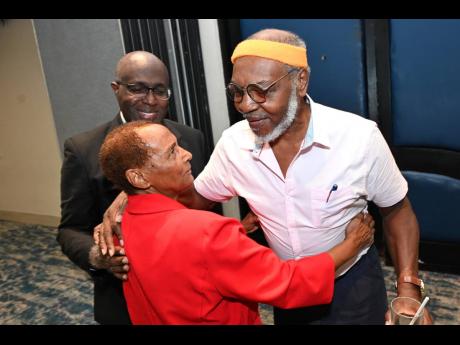 Desmond Richards (right), former president of the Press Association of Jamaica (PAJ), greets veteran Gleaner journalist Barbara Gayle while Gary Allen, group senior executive at RJRGLEANER Communications Group, looks on during the PAJ Veterans’ Luncheon 