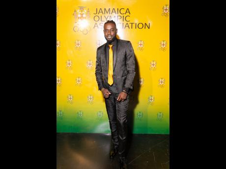 Hurdler and men’s 110m hurdles bronze medallist Rasheed Broadbell shows his national pride in an all-black Max Brown suit accented with a touch of gold.