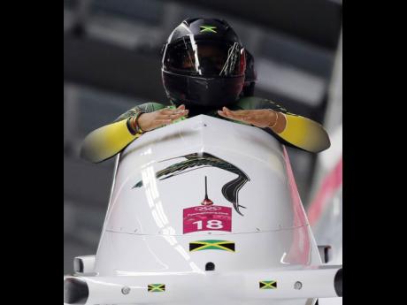 Driver Jazmine Fenlator-Victorian and Carrie Russell of Jamaica finish a heat during the women’s two-man bobsled competition at the 2018 Winter Olympics in Pyeongchang, South Korea, on Tuesday, February 20, 2018. 