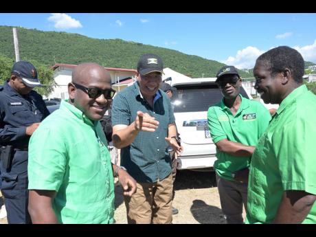 Credit: Rudolph Brown Jamaica Labour Party leader and Prime Minister, Andrew Holness (second left), enjoys a moment with newly elected member of parliament for St Andrew North Western, Duane Smith (left). Desmond McKenzie, minister of local government and community development;