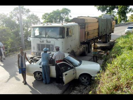 Credit: Gleaner File In this August 2007 photo, the police are responding to an accident scene on Spur Tree Hill.