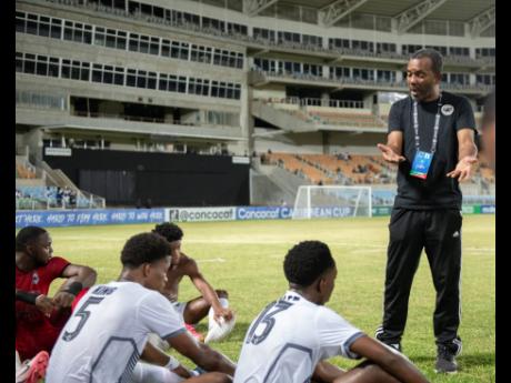 Credit: Gladstone Taylor Rudolph Speid (right) speaking with his Cavalier charges during a Concacaf Caribbean Cup game against Trinidad and Tobago’s Police FC at Sabina Park in September.