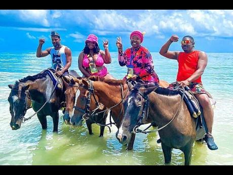 Visitors about to enjoy swimming with the horses at an attraction in Sandy Bay, Hanover.