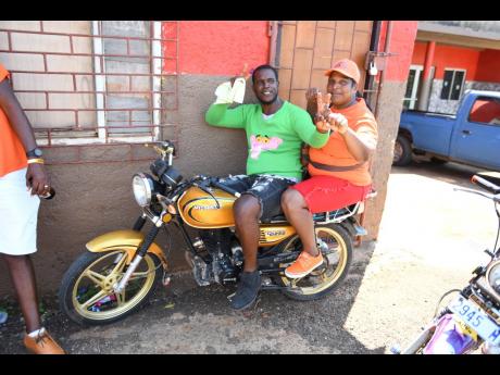 Supporters of PNP and JLP pose for a photograph at Plowden community in Manchester during local government election in February.