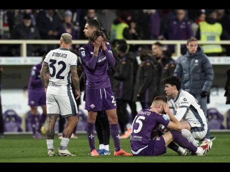 Emotional players comfort each other as Fiorentina’s Edoardo Bove is taken to hospital during the Serie A match between Fiorentina and Inter at the Artemio Franchi Stadium in Florence, Italy, yesterday. The match was suspended and finally postponed. 