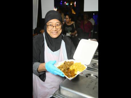 Credit: Nathaniel Stewart Zanifa Khan from Khazana Foods shows off her curried duck, curried goat and curried chicken.