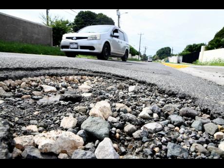 A pothole on Deanery Road in Vineyard Town that was caused by rainfall in November 2020.