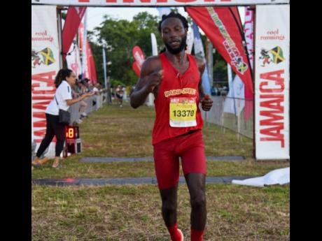 Credit: Ashley Anguin Jamaica’s Kemar Leslie captures the men’s half marathon in 1:15:46 at the 24th Reggae Marathon in Negril, Westmoreland, yesterday.