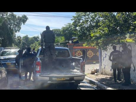 Members of the security forces on patrol along St John’s Road in Rockfort, Kingston, on Monday.