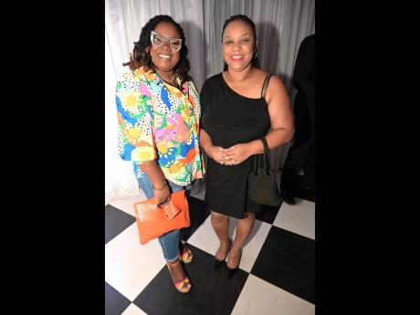 Say wealth! Pairing up for a photo op are Charlene Edwards (left), acting accountant of JCCUL, and Camelia McLeish, accountant of Lascelles Employees and Partner Credit Union.  