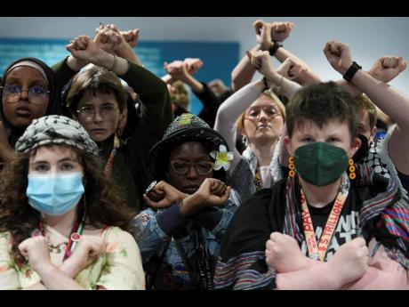 Credit: Joshua A. Bickel Activists demonstrate in silence, protesting a draft of a proposed deal for curbing climate change at the COP29 UN Climate Summit on November 22 in Baku, Azerbaijan.