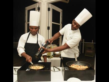 The Tryall Club’s chefs Andrew Grant (left) and Orien Lestly prepare the shrimp pasta and clams. 