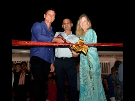 From left: Kenton Jones, managing director, The Tyrall Club, cuts the ribbon with Suresh Kavan, board member of The Tryall Club, and Julia Merck-Utsch, president of the board, during the grand opening of the Ooshan Restaurant and Bar at The Tyrall Club.