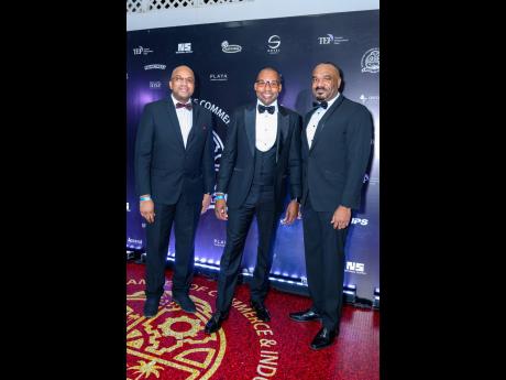 Men in black: Powerbrokers (from left) Errol Barnaby, EXIM Bank’s acting chief executive officer; Hugh Grant, president of the Jamaica Public Service; and Winston Lawson, trade manager EXIM Bank, sharing lens time at the 92nd Annual Montego Bay Chamber o
