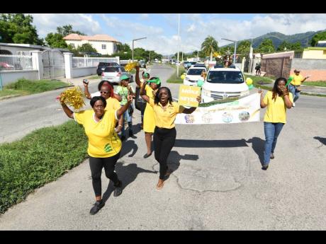 Members of staff, students and parents making their way along the parade route.