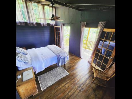 The relaxing bedroom leads to a balcony.