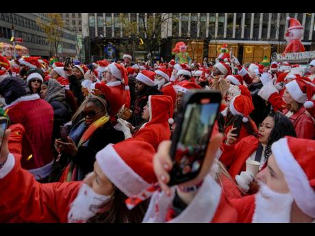 
Revellers take part in SantaCon in New York on Saturday.