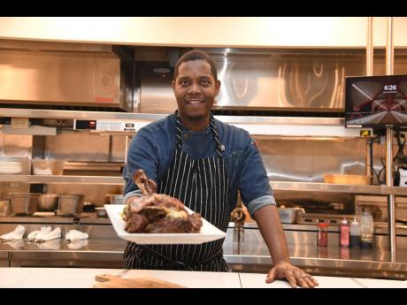 Craig Green, lead chef, One Park, presenting the tomahawk served with cowboy butter, at New Kingston’s newest restaurant. 