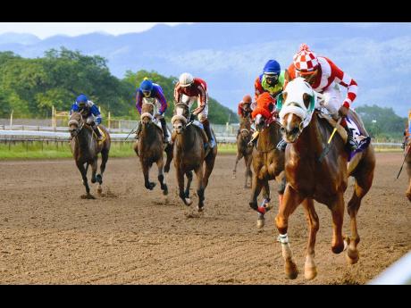File photo shows FURTHER AND BEYOND (right), ridden by Ian Spencer winning the Two-Year-Old Stakes at Caymanas Park in 2020.
