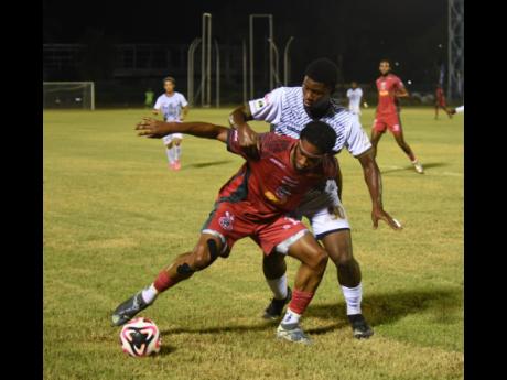 Montego Bay United’s Dwayne Allen (left) shields the ball from  Cavalier’s Alexavier Gooden during their Jamaica Premier League match at the Montego Bay Sports Complex on Wednesday, December 18, 2024. The match ended in a 1-1 draw.