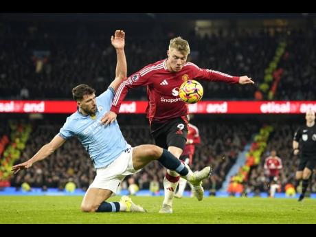 Manchester City’s Ruben Dias (left) challenges for the ball with Manchester United’s Rasmus Hojlund during the English Premier League  match between Manchester City and Manchester United at the Etihad Stadium in Manchester on Sunday, December 15, 2024.