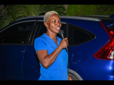 Sandra Karr, vice-president of the Caymanas Country Club Estate Citizens’ Association, addressing a vigil held in memory of Barbara Gayle last Thursday night.