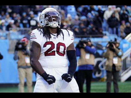 Credit: AP Arizona Cardinals running back DeeJay Dallas celebrates after scoring against the Carolina Panthers during the first half of an NFL football game in Charlotte, North Carolina, yesterday.