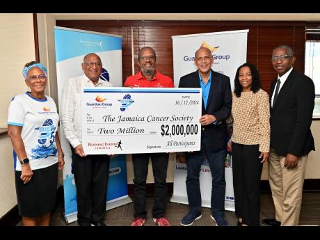  Eric Hosin (third right), Group President, Life, Health & Pension Guardian Life Ltd,  presents a cheque for $2 million to Michael Jureidni (second left) of Brothers United Against Prostate Cancer, who collected it on behalf of the  Jamaica Cancer Society.