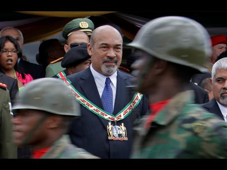 FILE – In this August 12, 2010 file photo, Suriname’s President Desi Bouterse attends a military parade after his swearing-in ceremony in Paramaribo, Suriname. 