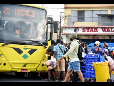 In this 2023 photo, commuters are seen jostling to board a Jamaica Urban Transit Company bus at the South Parade terminus in downtown Kingston. Mark Wignall writes: Any subject that veers too close to what some arch conservatives deem is a socialist dream 