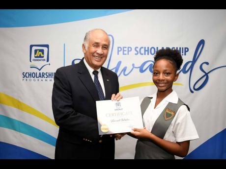 Kiarrah Wisdom (right) receives her certificate from Parris Lyew-Ayee, Chairman of the JN Foundation, after being named JN Foundation’s PEP Scholarship winner for St James during the scholarship reception held recently.