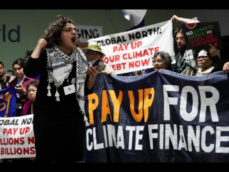 Activists participate in a demonstration for climate finance at the COP29 U.N. Climate Summit, Friday, November 22, 2024, in Baku, Azerbaijan.