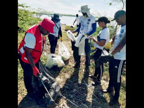Michael Gordon, chairman of the Emergency Service Section of the Jamaica Red Cross (left), works with Forestry Department volunteers, including (from second left) Shanieka Mighten, forest technician; Ainsley A. Henry, CEO & conservator of Forests; Renee Ri