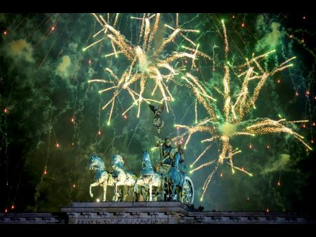 Fireworks light the sky above the Quadriga at the Brandenburg Gate during New Year’s celebrations shortly after midnight in Berlin, Germany, Wednesday, Jan 1, 2025. 