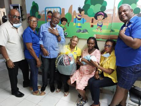 From left: Rafael Williams, friend of Rotary; Lorna Williams, member of the Savanna-la-mar Rotary Club; Oliver Green, past assistant governor; and Christine Green, past assistant governor; pose with Leana Sewell, and her baby Tahir Whitelocke, as well as p